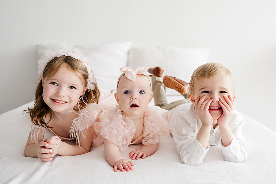 3 kids laying next to each other