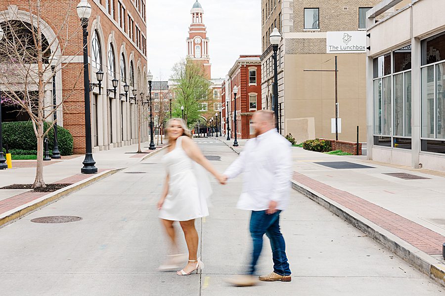 walking across gay street at downtown knoxville engagement