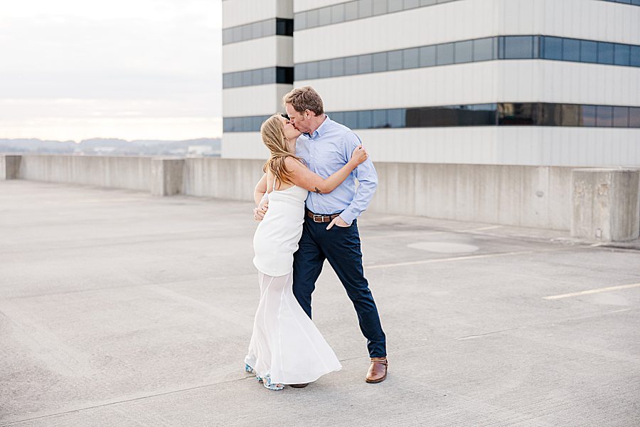 couple kissing on top deck of parking garage