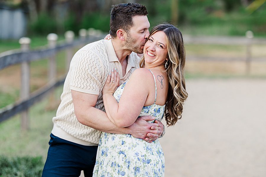 man kissing woman on cheek