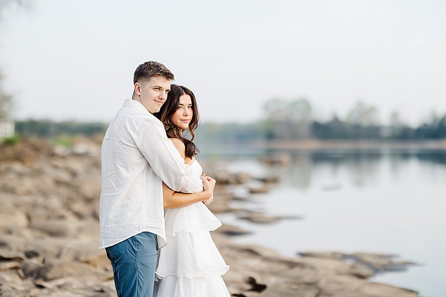 couple standing by small river