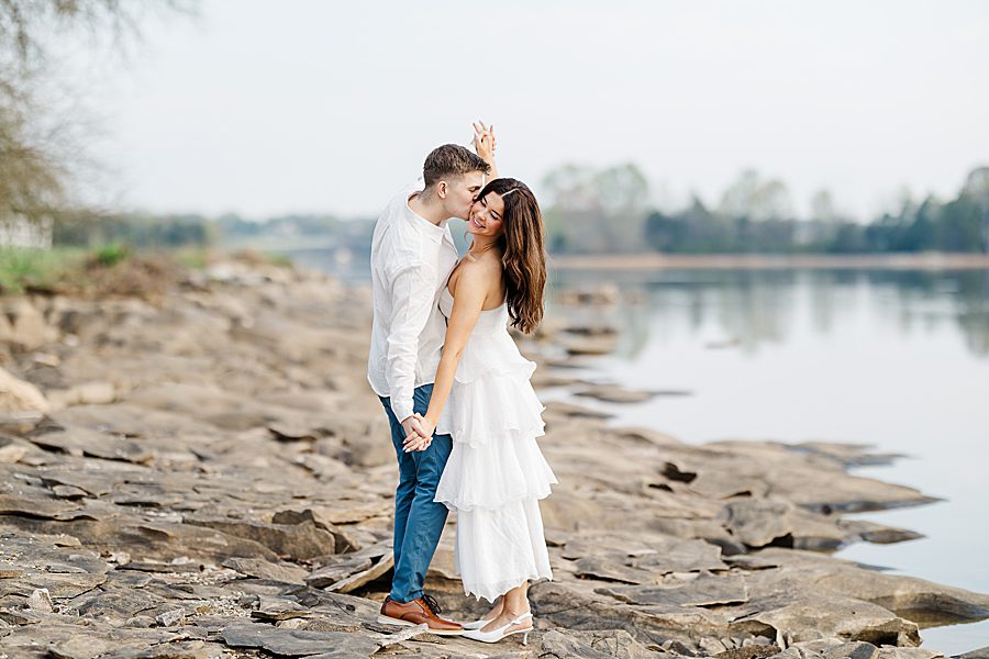 couple standing on sandy beach