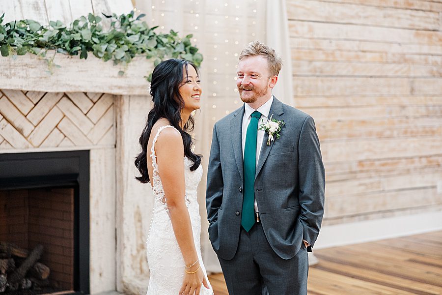 bride and groom first look at rainy wedding at ramble creek