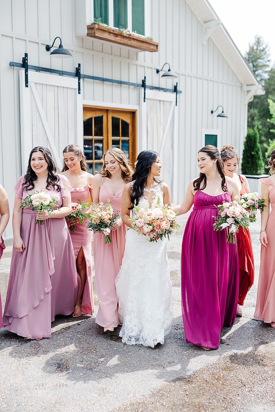 bride and bridesmaids walking at rainy wedding at ramble creek