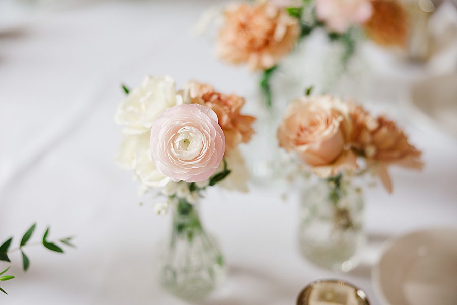 flowers in bud vases at rainy wedding at ramble creek
