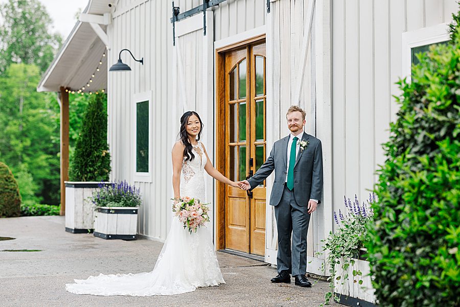 holding hands at rainy wedding at ramble creek