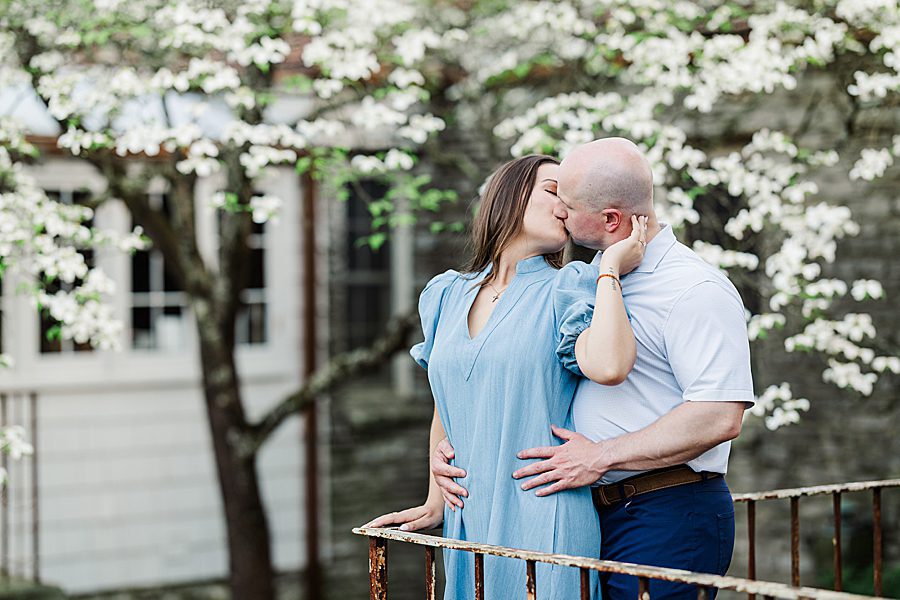 couple kissing on metal balcony