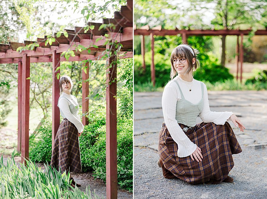 girl standing next to red arbor at ut gardens senior session