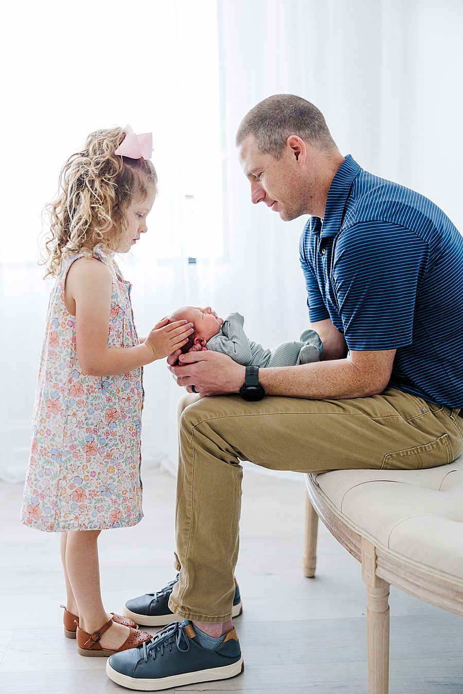 dad holding son while daughter looks on