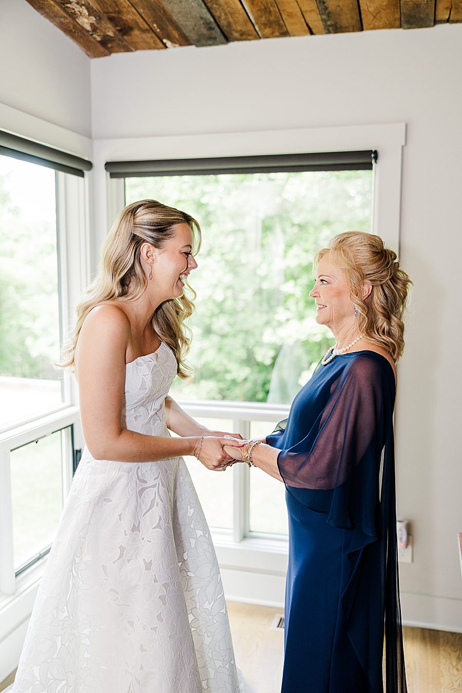 bride and mom holding hands