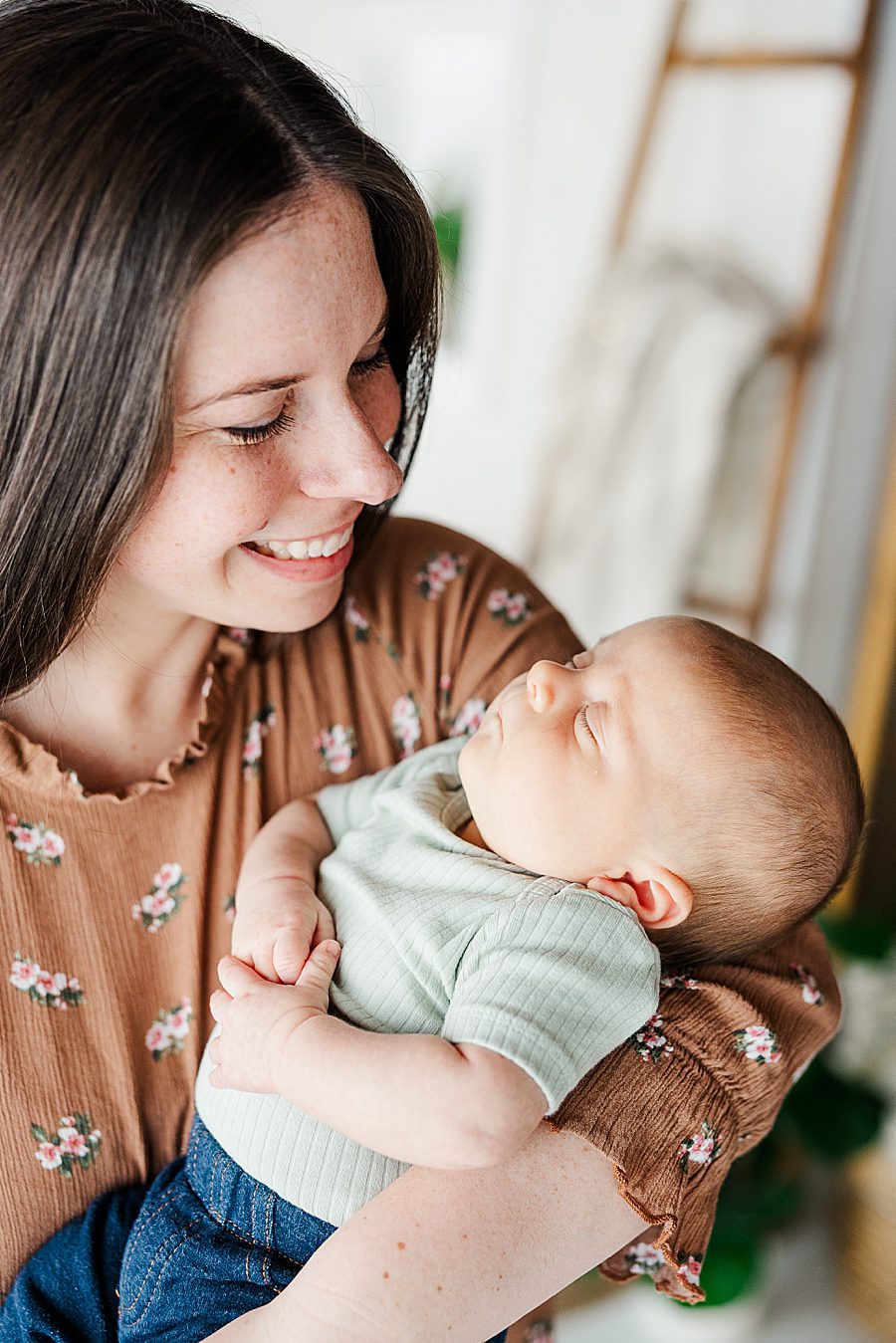 mom holding son at six week session
