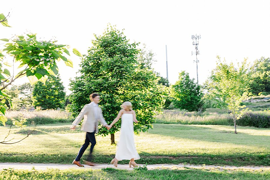 couple running through garden at golden hour