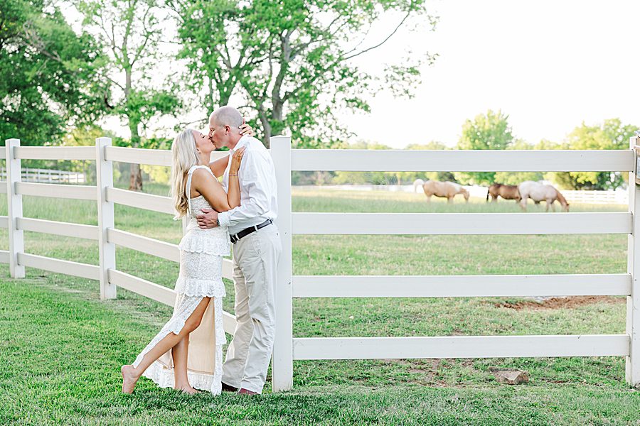 couple standing by horse pasture