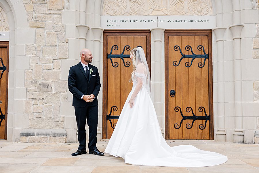 bride and groom first look at press room catholic wedding