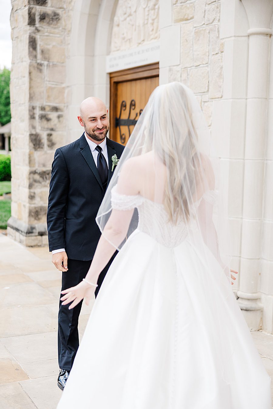 groom seeing bride at press room catholic wedding