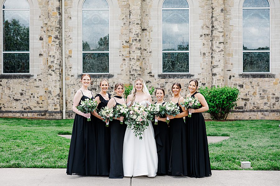 bride and bridesmaids at press room catholic wedding