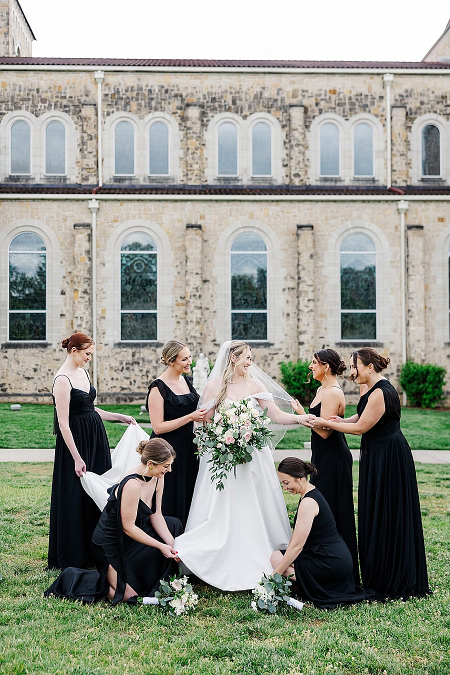 bridesmaids tending to bride at press room catholic wedding