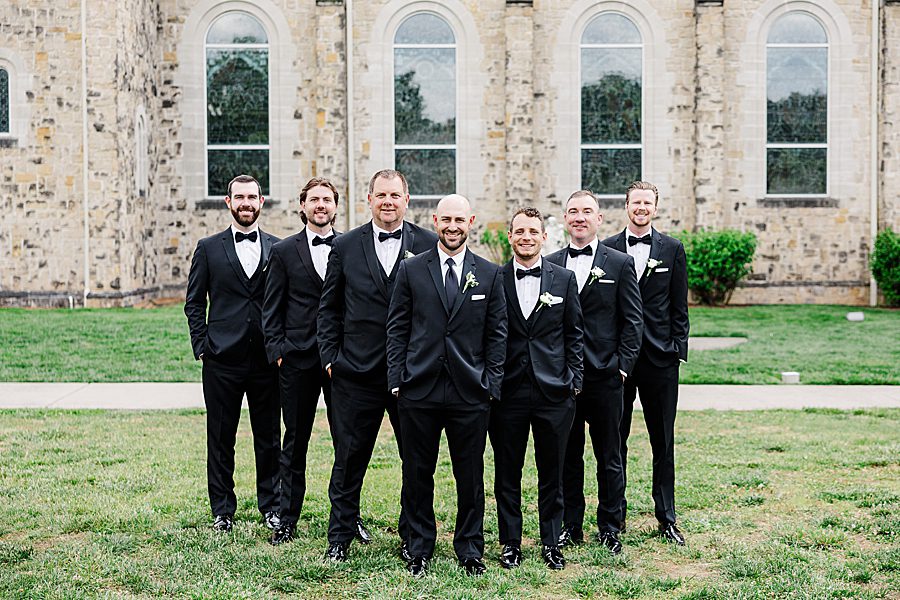 groom and groomsmen at press room catholic wedding