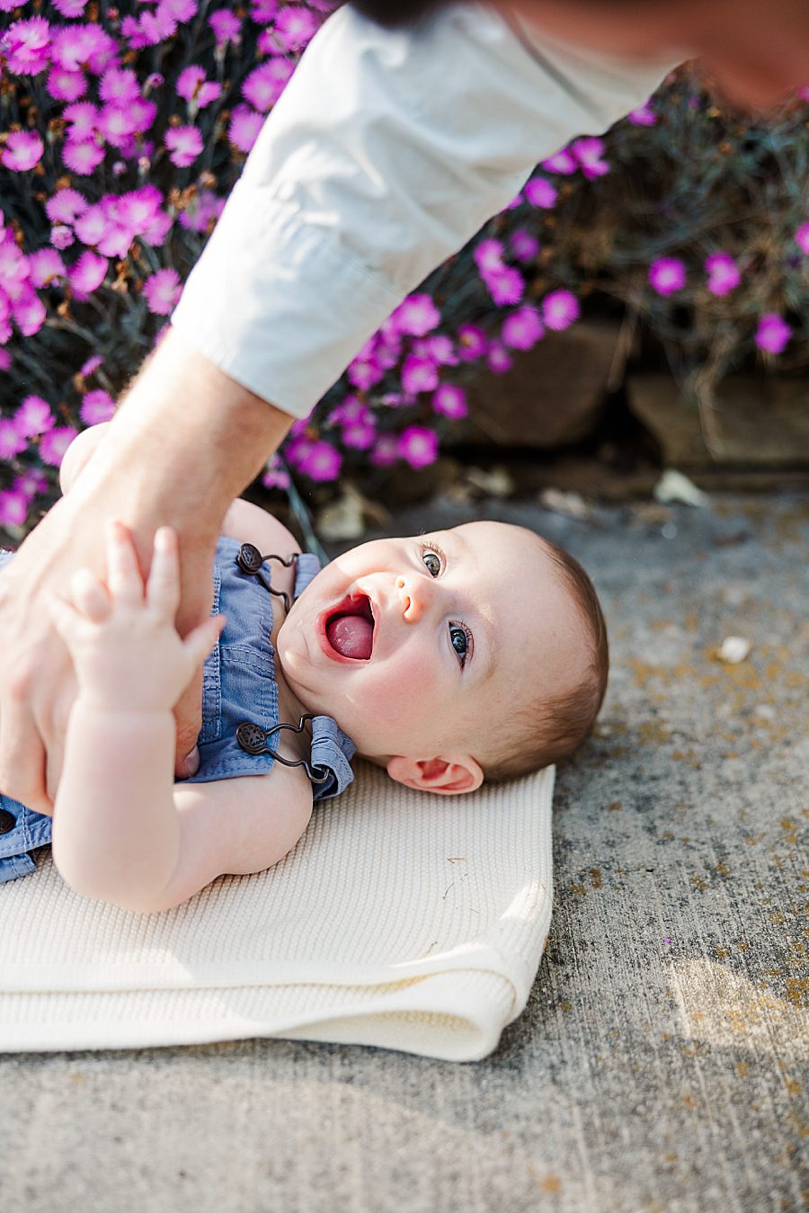 dad tickling baby boy at spring 6 month session