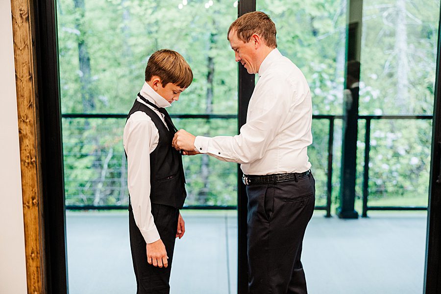 son getting ready for parents' trailhead venues wedding