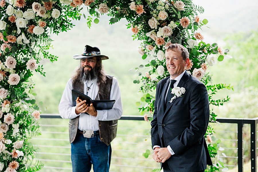 groom seeing bride walking down aisle at trailheads venue wedding