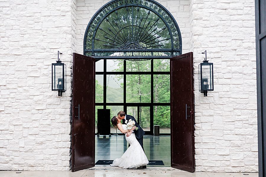 bride and groom photo in front of stone building
