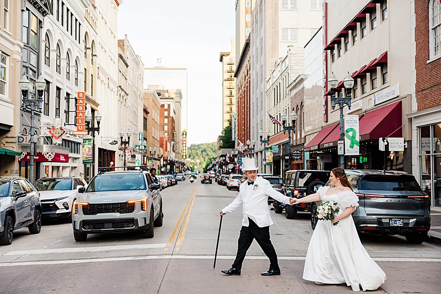 couple walking across gay street at world's fair site anniversary session