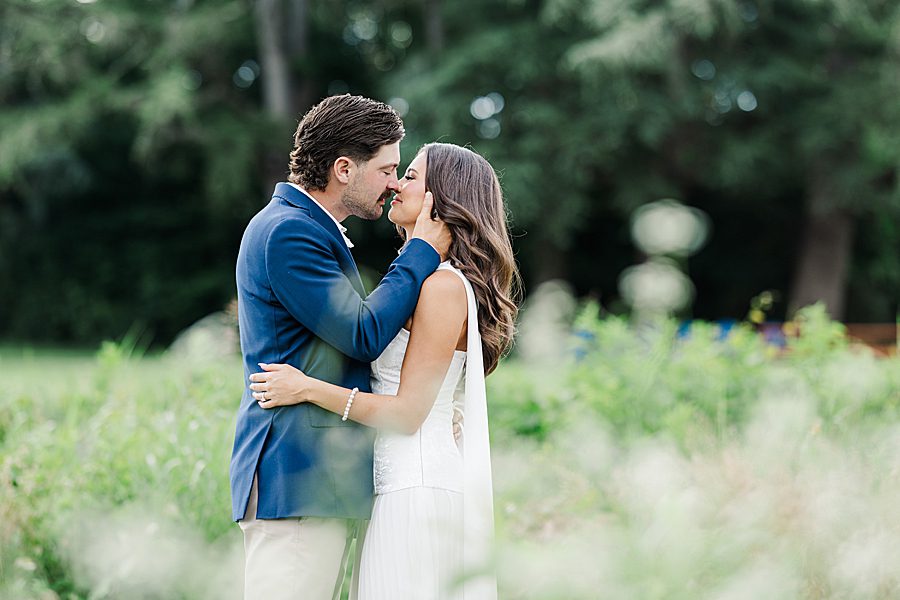 couple kissing at garden engagement session