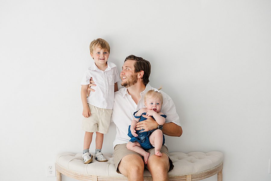 dad and kids sitting on bench