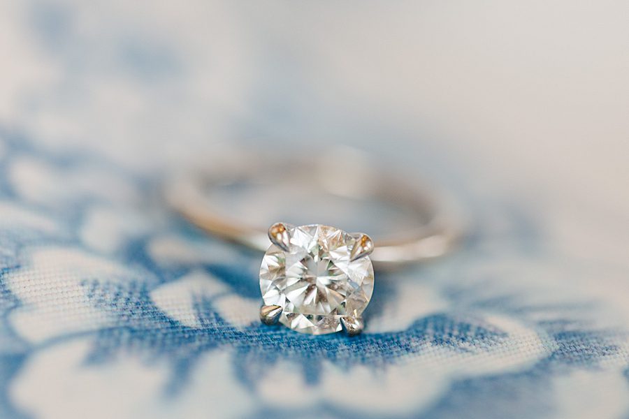 engagement ring on blue flower fabric at rainy marblegate engagement