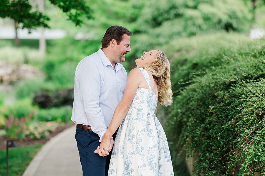couple laughing together at rainy marblegate engagement