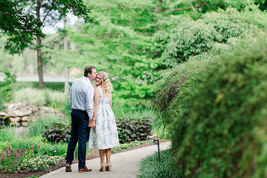kiss on cheek at rainy marblegate engagement