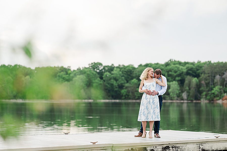 couple standing on dock by water