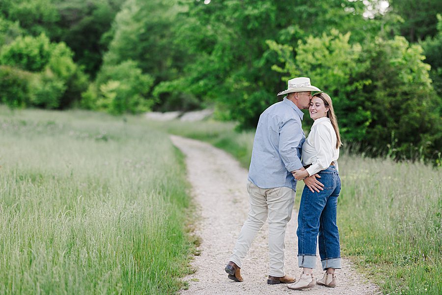 man kissing woman on cheek