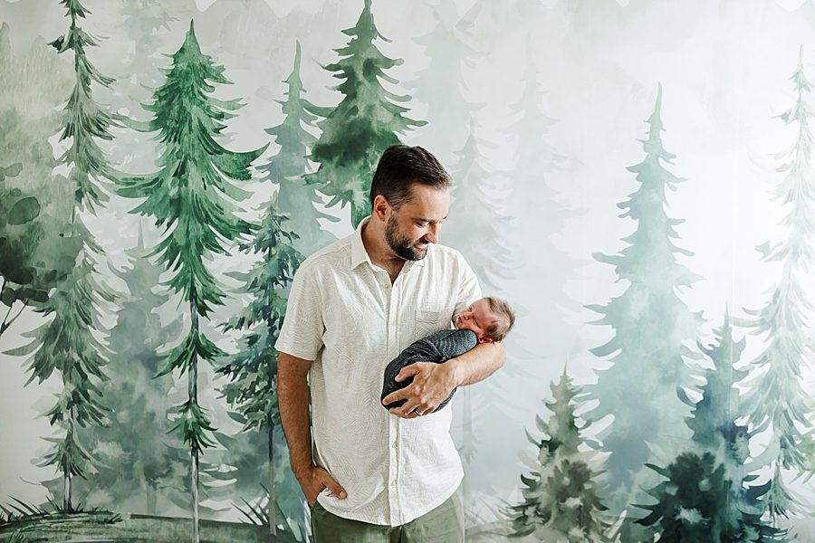 dad holding son at newborn family session