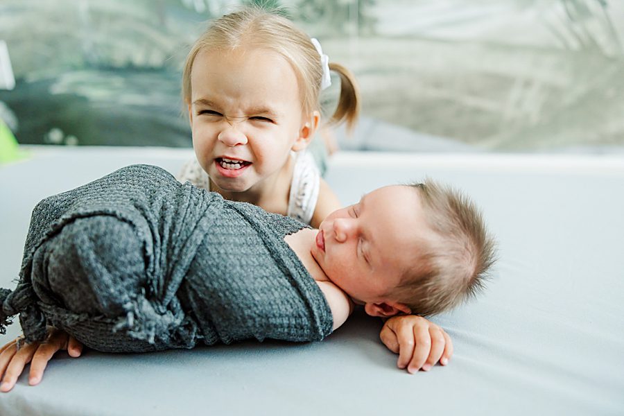 happy big sister at newborn family session