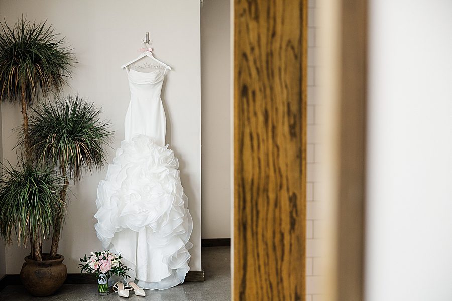 wedding dress on hanger at summer press room wedding