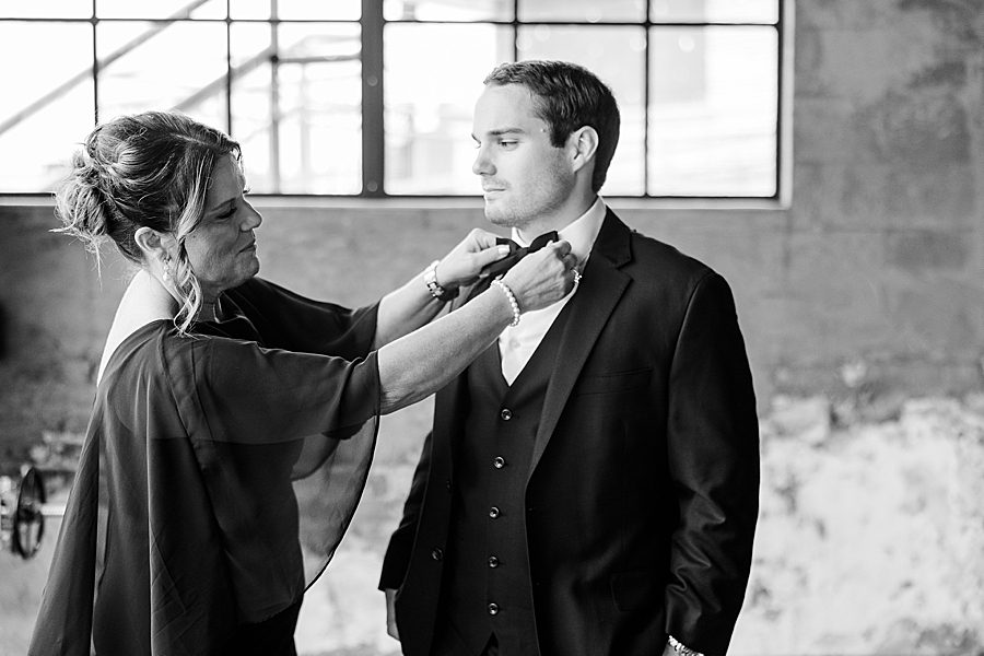 groom getting ready for summer press room wedding