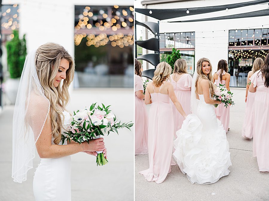 bride looking at bouquet before summer press room wedding