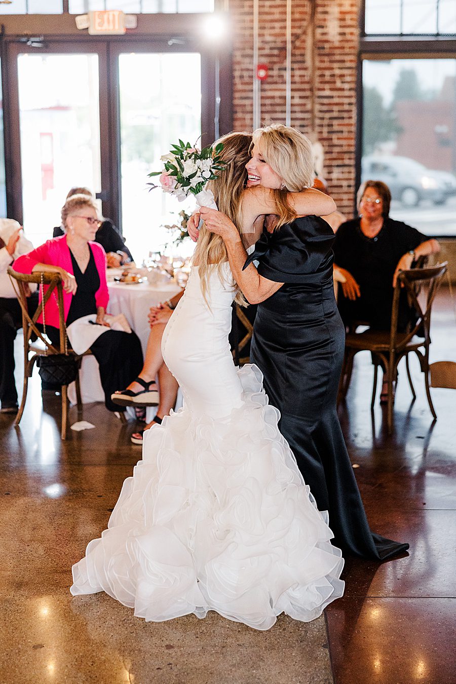 bride dedicating bouquet to mother
