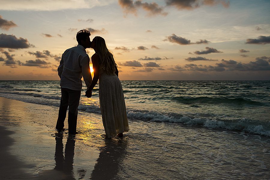 couple kissing at sunset on beach