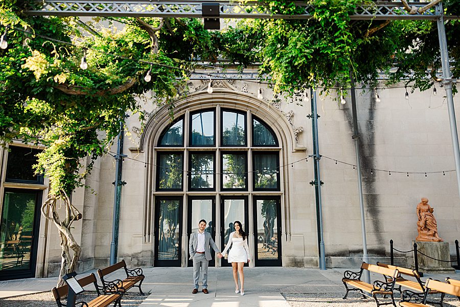 couple in front of windows at biltmore estate engagement session