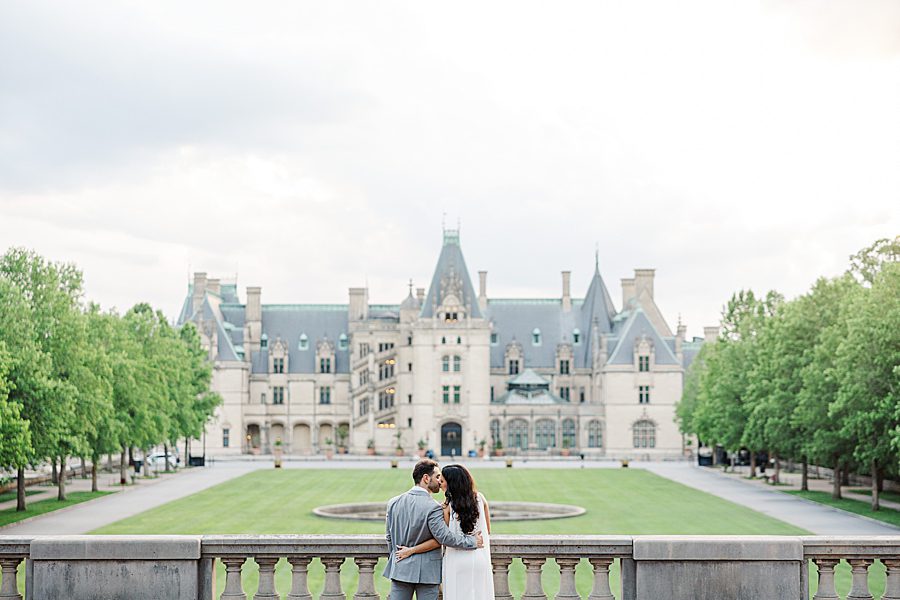 couple standing in front of mansion