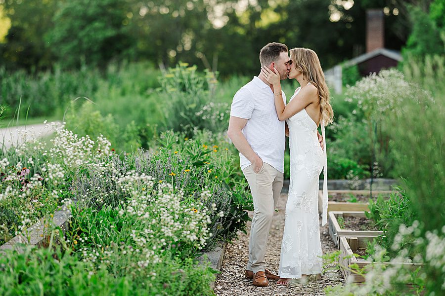 couple kissing on garden path