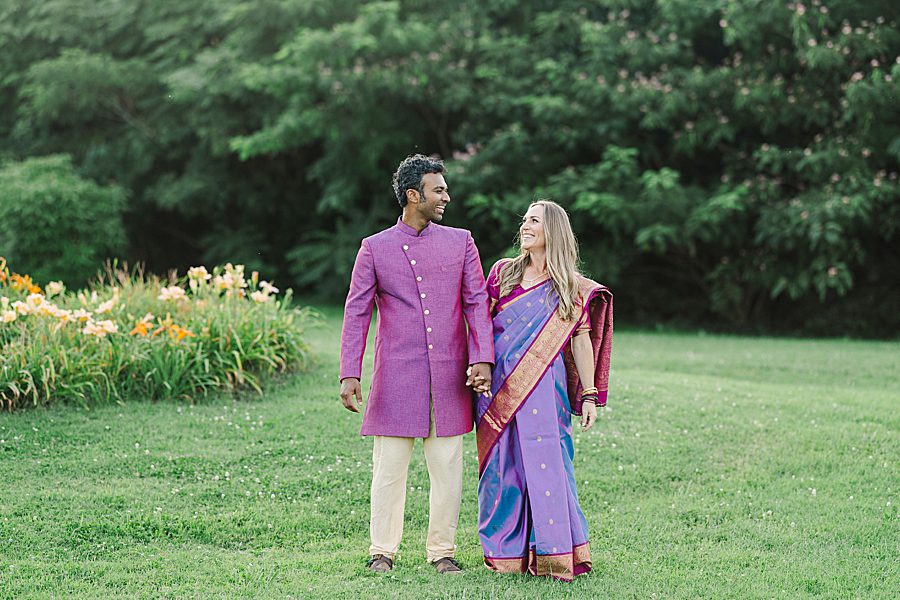 couple holding hands during lakeshore park wedding portraits