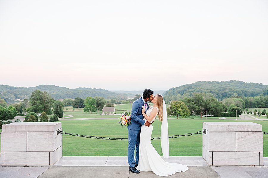 golden hour kiss at lakeshore park wedding portraits