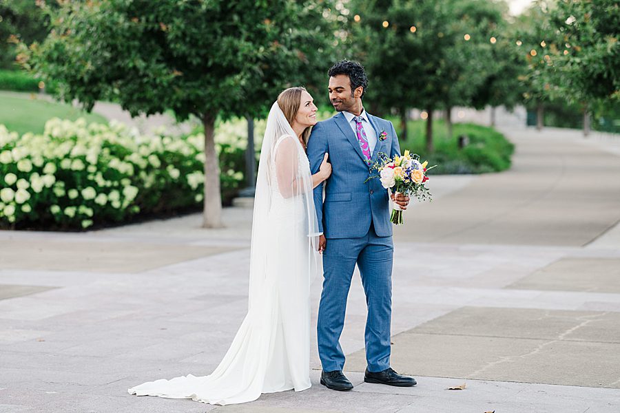 photo of couple with man holding bouquet