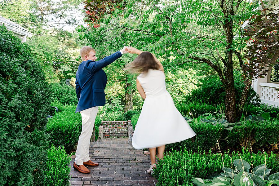 couple twirling at maple grove engagement session