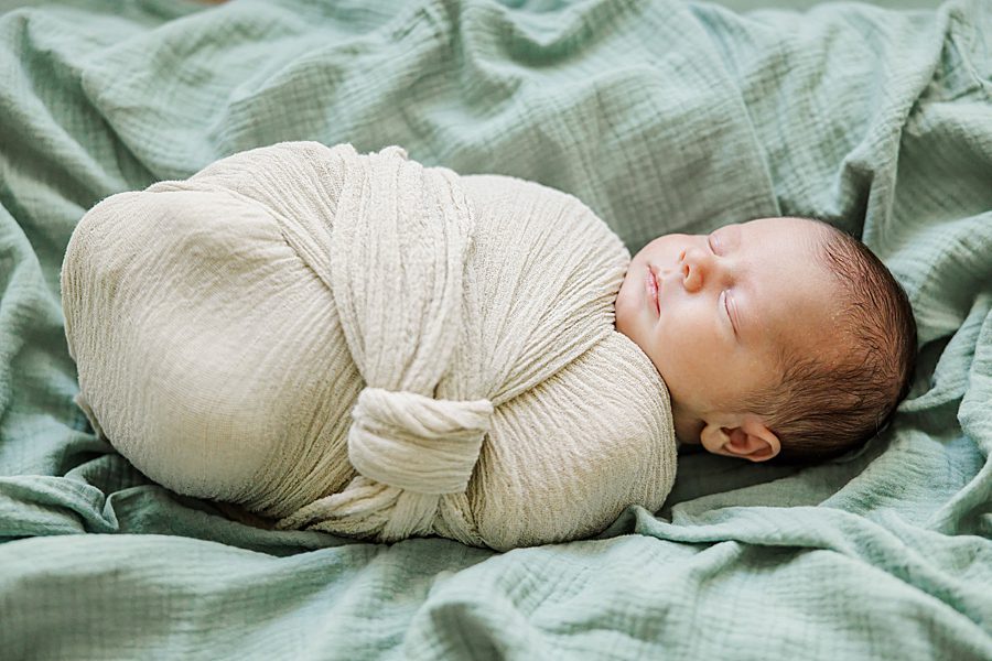 swaddled baby boy at home newborn session