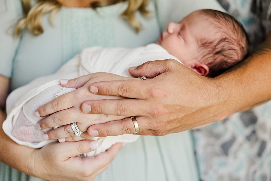 mom and dad holding son